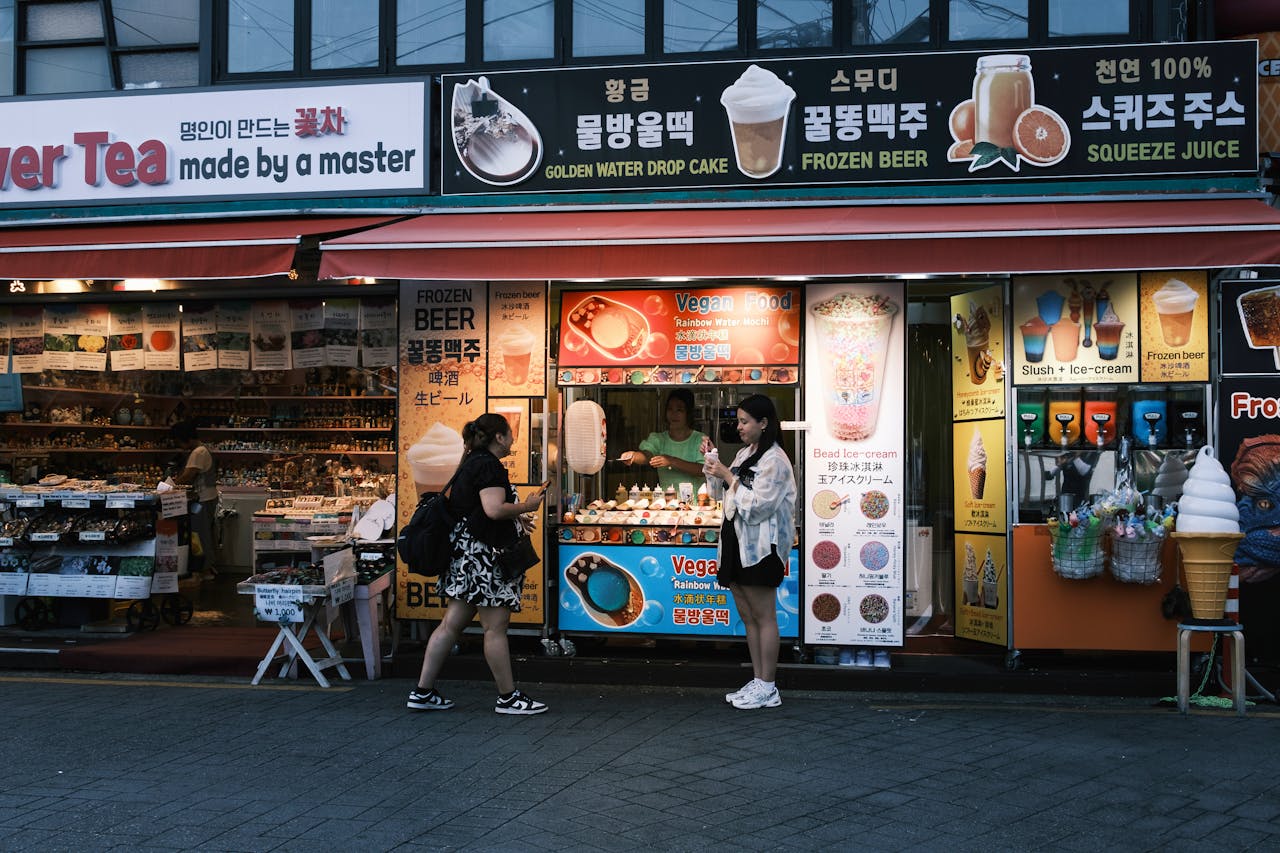 Vibrant street food stand offering diverse snacks and drinks, captured at dusk.